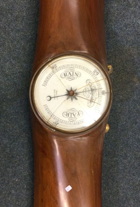A large mahogany barometer in the form of a propel