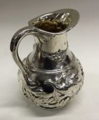 A Victorian silver water jug chased with animals. Approx. 42 grams. Est. £120 - £150.
