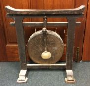 A large oak framed dinner gong of Chinese design.