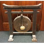 A large oak framed dinner gong of Chinese design.