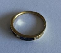 A diamond and sapphire half eternity ring set in g