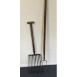 An old vintage hay fork together with one other. E