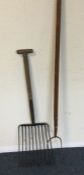 An old vintage hay fork together with one other. E