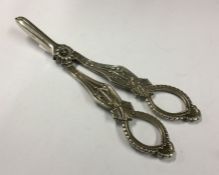 A pair of heavy cast silver grape scissors of typi