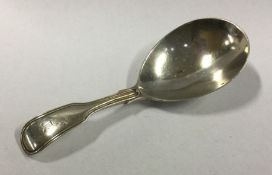 A silver fiddle pattern caddy spoon. London. By GS