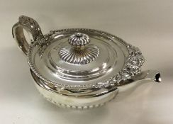 A decorative George III silver teapot chased with