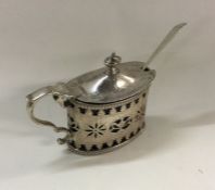 A decorative Victorian silver pierced mustard pot.