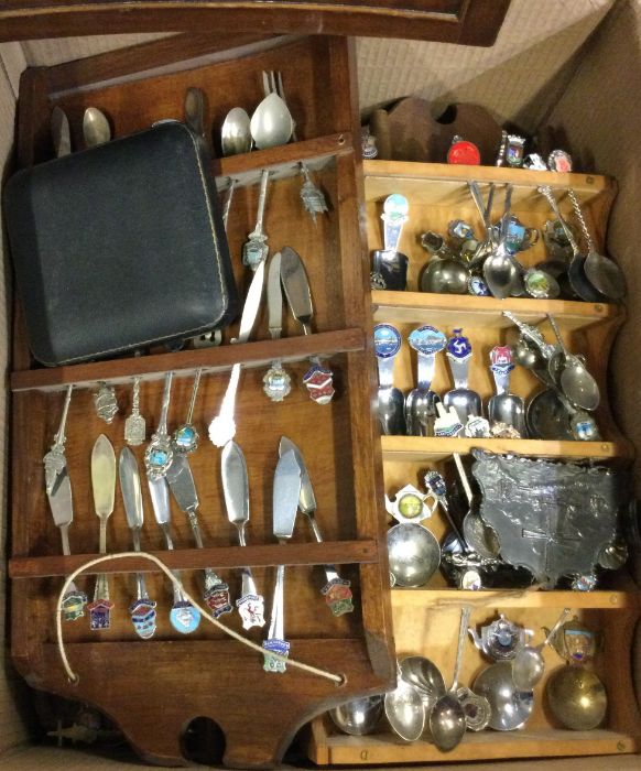 A large box of souvenir spoons.