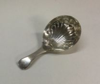 A George III silver caddy spoon with fluted bowl.