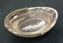 A George III shaped silver swing handled basket wi