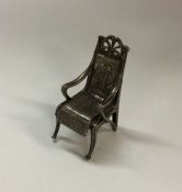 A heavy silver model of a miniature chair. Approx.