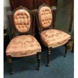 A pair of Victorian button back chairs.