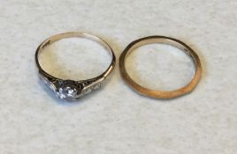 A small diamond single stone ring together with a