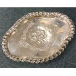 A heavy silver dressing table tray attractively de