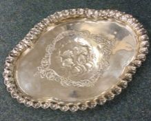 A heavy silver dressing table tray attractively de