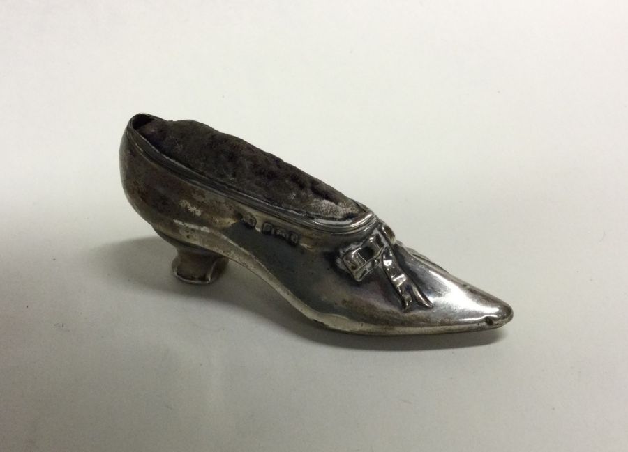 A novelty silver pin cushion in the form of a shoe