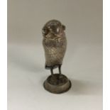 A heavy silver figure of an owl on stand. Approx.