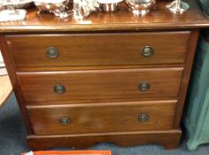 A mahogany chest of three drawers.