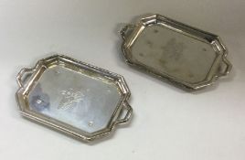 A good pair of silver engraved trays with flowers.