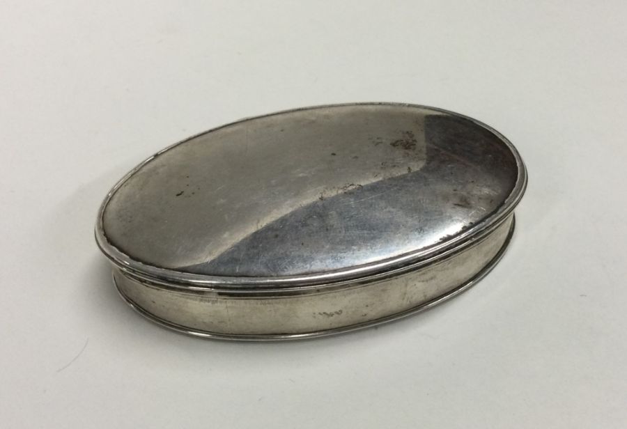 A Georgian silver oval box with hinged cover. Punc