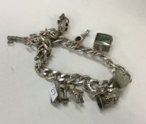 A heavy silver curb link charm bracelet. Approx. 5