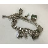 A heavy silver curb link charm bracelet. Approx. 5