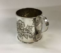 A decorative George III chased silver mug. London