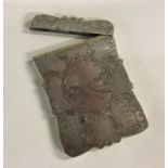 A heavily engraved Victorian silver card case depi