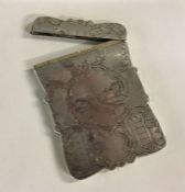 A heavily engraved Victorian silver card case depi