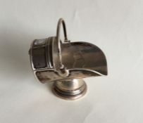 A novelty silver coal scuttle on turned supports.