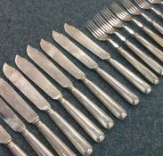 A set of eight (plus eight) silver fish knives and