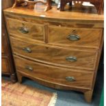 A mahogany bow front chest of four drawers.