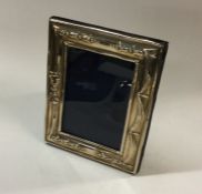 A chased silver picture frame. London. By Richard