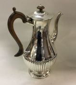 A bright cut Victorian silver coffee pot. London 1