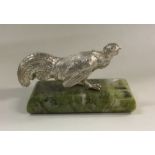 A heavy silver figure of a bird on marble base. Ap