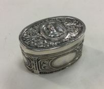 A heavy large oval German silver box decorated wit