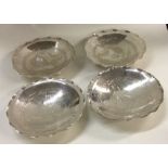 A good set of four Chinese silver dishes on feet.