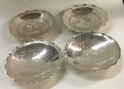 A good set of four Chinese silver dishes on feet.
