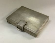 A heavy textured silver compact. Approx. 154 grams