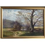 A gilt framed oil on canvas depicting a wooded str