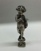 A heavy cast silver seal depicting a child in stan