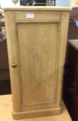 A stripped pine bedside cabinet.