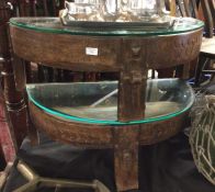 A pair of hardwood glass top tables.