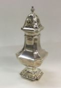 A large silver shaped sugar caster. London. Approx