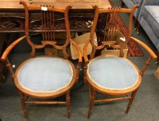 A pair of Victorian satinwood chairs.