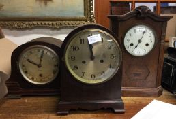 A group of three oak cased clocks.