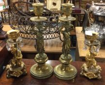 Two good pairs of brass candlesticks.