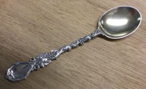 A decorative Victorian silver dessert spoon with c