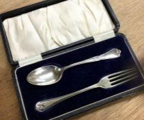 A Victorian silver fork and spoon with chased deco