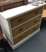 A pine chest of three drawers.